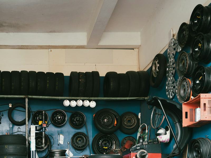 Sample photo: tires racked on a shelf and wheels hung on a shop wall